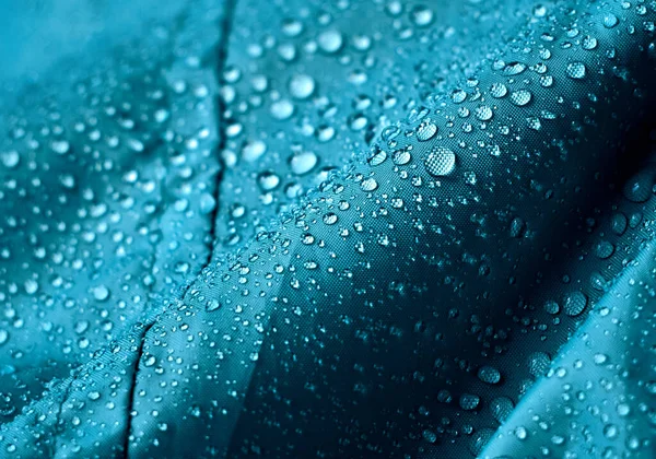 Gotas Agua Lluvia Sobre Tela Impermeable Fibra Azul Fondo Azul —  Fotos de Stock