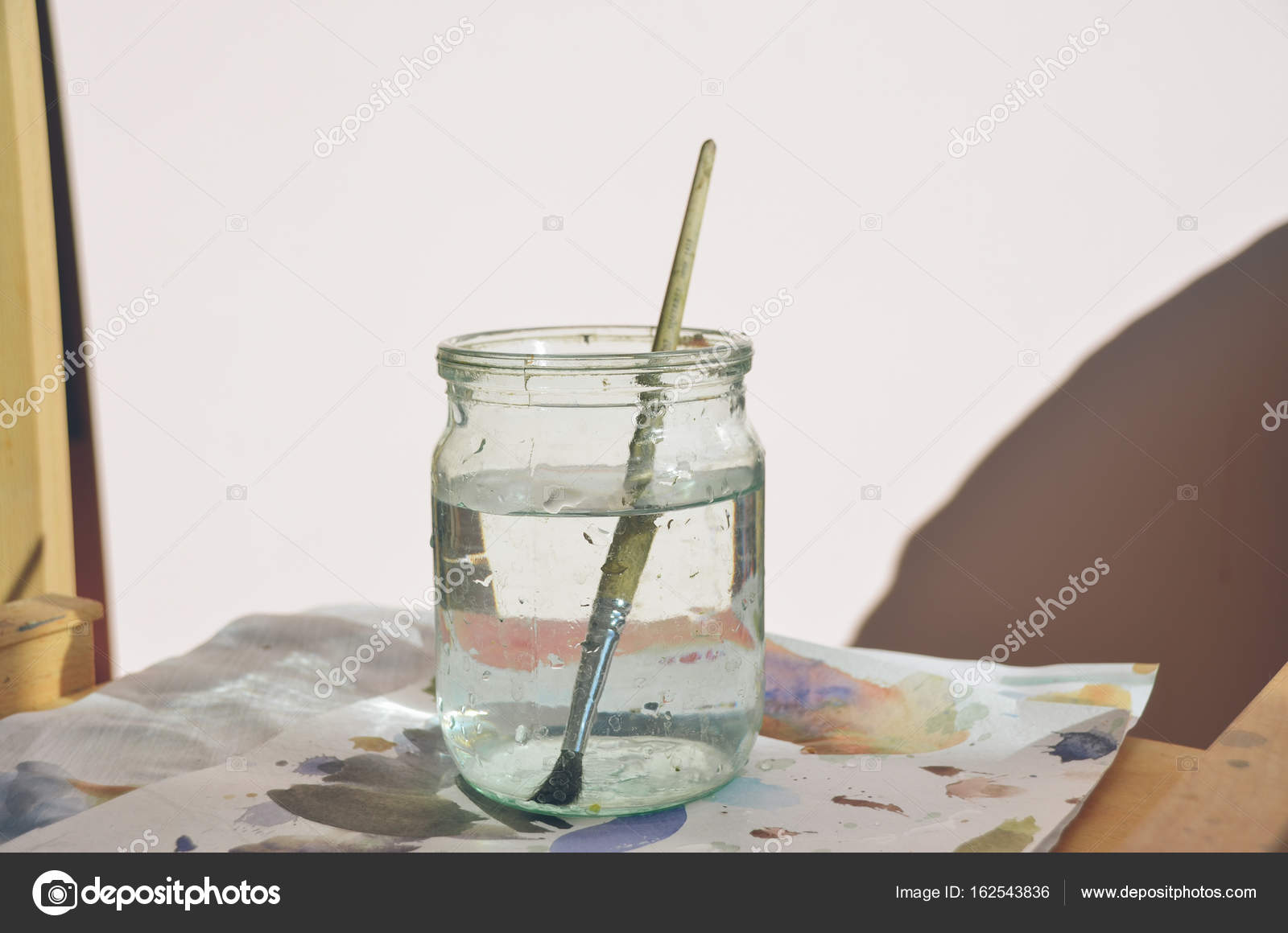 Paintbrush in jar with clean water — Stock Photo © KatherinePirs 162543836