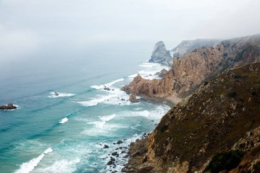 Kayalıklar Atlantik Okyanusu' nda sisle kaplıdır, Portekiz' in Cascais kenti yakınlarındaki Cabo da Roca' da doğal bir manzara. Avrasya kıtasının en batı pelerini.