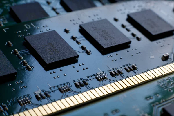 Contacts, connecting tracks and microchips of a computer RAM Random Access Memory modules close-up for electronic design. Selective focus. — Stock Photo, Image