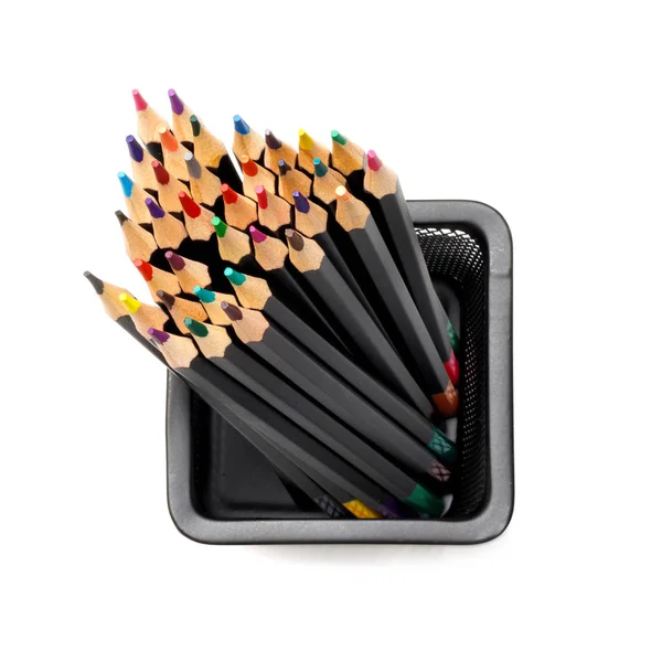 Colored pencils in a black shell in a metal mesh glass. View from above. Isolated on a white background — Stock Photo, Image