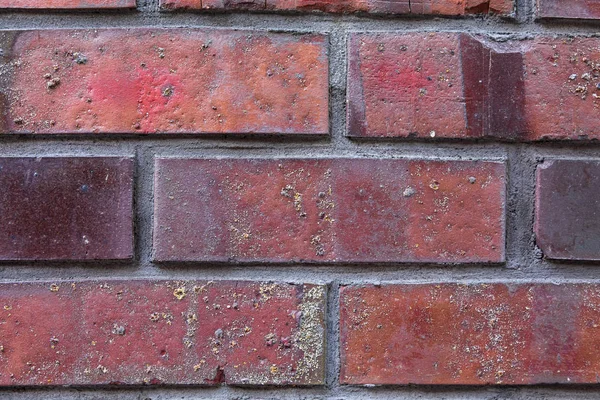 red glazed brick background. bricks of different shades close-up