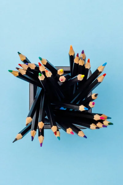 Colored pencils in a black office cup — Stock Photo, Image