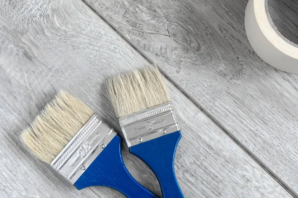 Set Two Blue Paint Brushes Adhesive Tape Gray Laminate Image — Stock Photo, Image