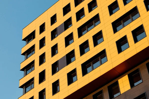 Yellow modern ventilated facade with windows. Fragment of a new elite residential building or commercial complex. Part of urban real estate. — Stock Photo, Image