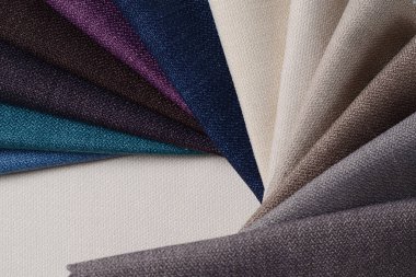 Topçu Tekstil örnekleri parlak topluluğu. Kumaş doku arka plan.