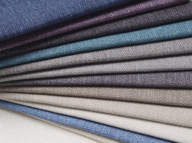 Topçu Tekstil örnekleri parlak topluluğu. Kumaş doku arka plan.