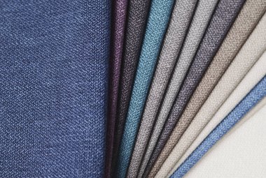 Topçu Tekstil örnekleri parlak topluluğu. Kumaş doku arka plan.