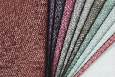 Topçu Tekstil örnekleri parlak topluluğu. Kumaş doku arka plan.