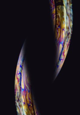 Sabun köpüğünün soyut makrosu. Sabun köpüğünün yüzeyi uzaydaki bir gezegene benziyor. Yaratıcı arkaplan.