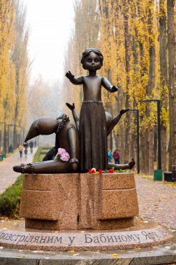 Kiev Ukraine - November 09, 2019. Granit Broken Doll and Toys, symbol monument to children executed in Babi Yar, place of massacres carried out by German forces during World War II. clipart