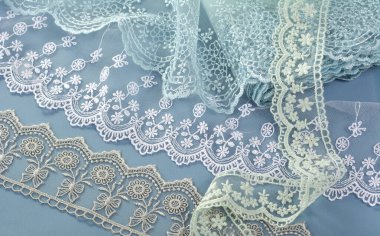 Mavi arka planda dantel kumaş yığını