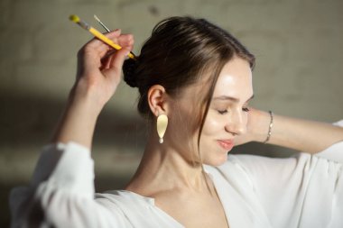 Portrait of beautiful fair young woman with jewelry, one light source