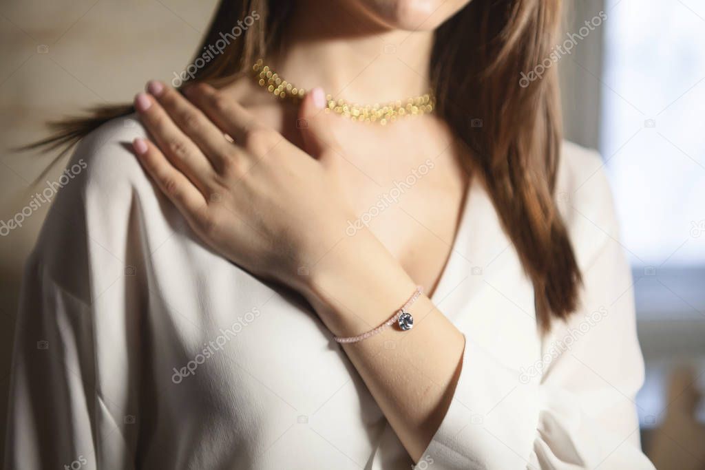 Portrait of beautiful fair young woman with jewelry, one light source
