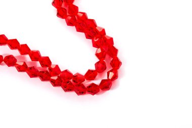 Beyaz arka planda güzel kırmızı cam kristal boncuklar. Küçük boncuklu mücevherler için kullan