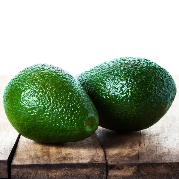 Avocado on wooden table — Stock Photo, Image