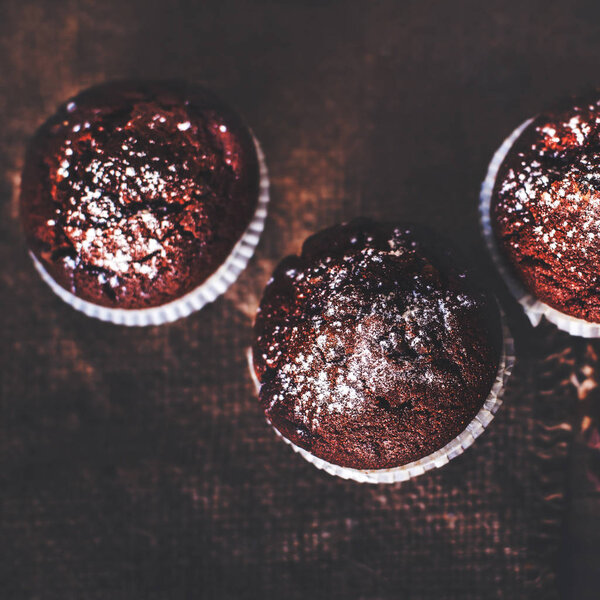 Chocolate dark muffins with powdered sugar 