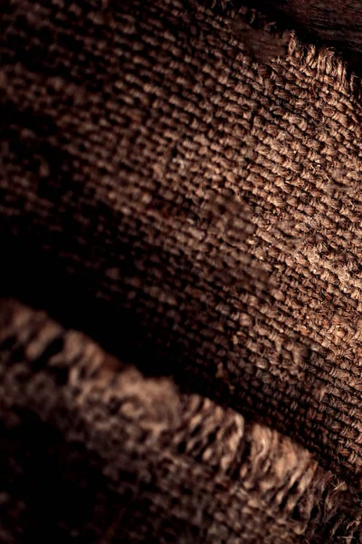 Burlap texture in dark interior — Stock Photo, Image
