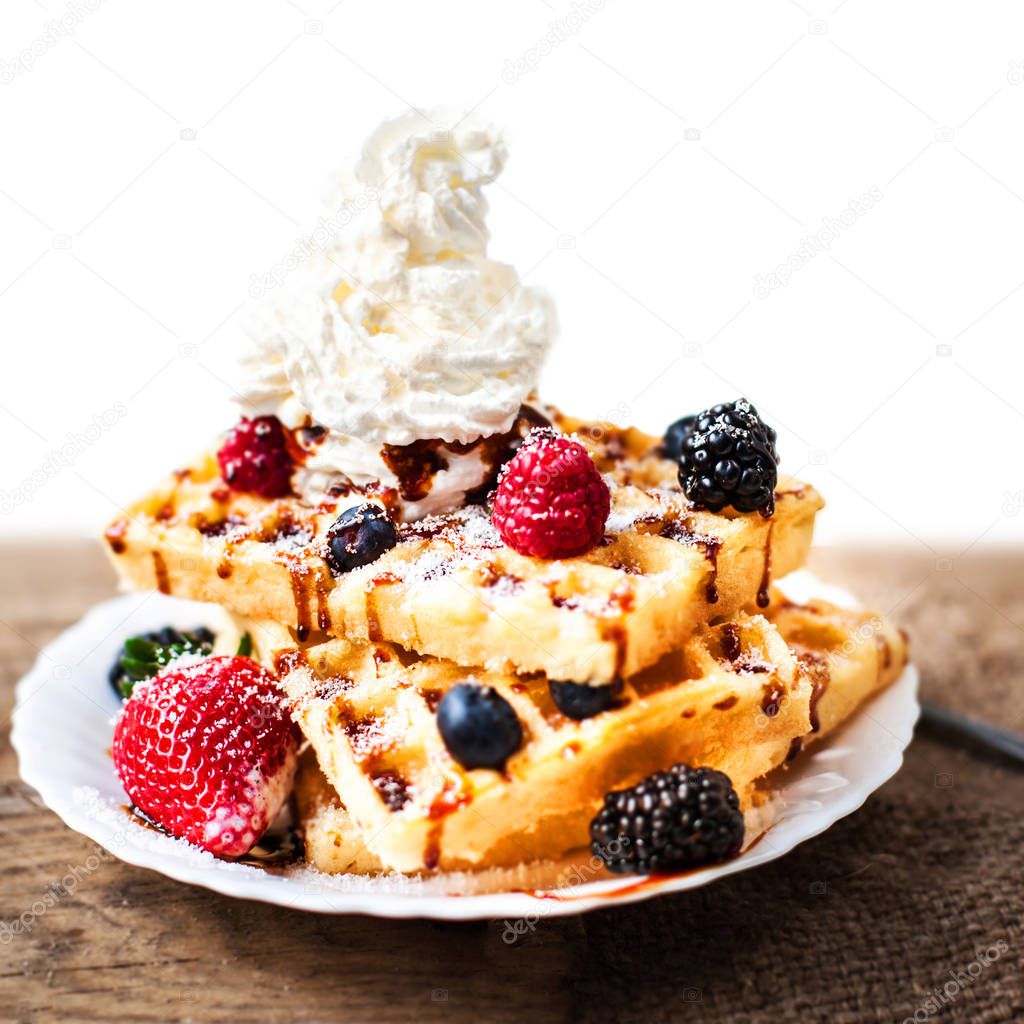 Belgian waffles with ice cream and berry fruits