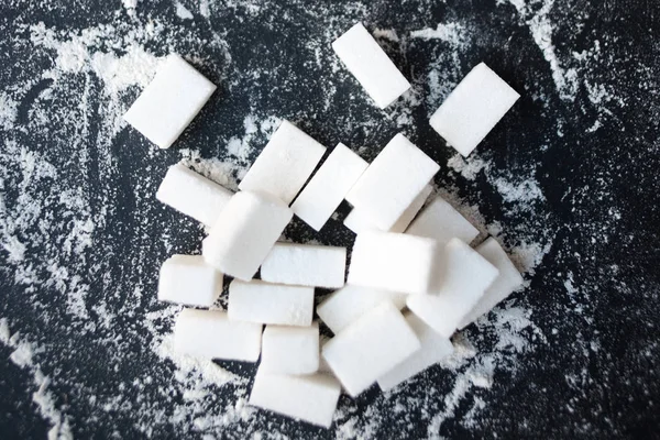 Sugar and flour on a black background — Stock Photo, Image