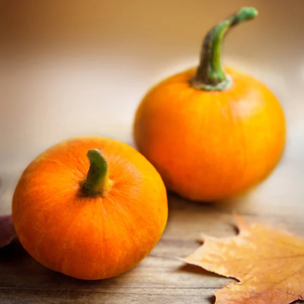 Zucche arancioni sul tavolo di legno — Foto Stock