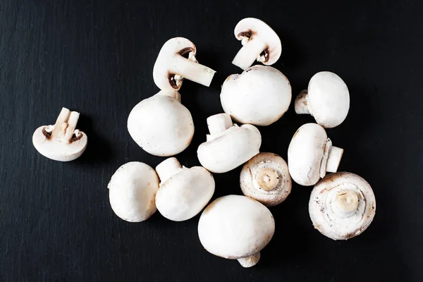 Fresh Mushrooms champignon on dark background, sliced and whole with copy space, ready for cooking — Stock Image Fresh Mushrooms Champignon Dark Background Sliced Whole Copy Space Ready Stock Image