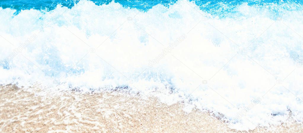 Soft wave of blue ocean on sandy beach Background with place for text. Tropical summer vacation concept