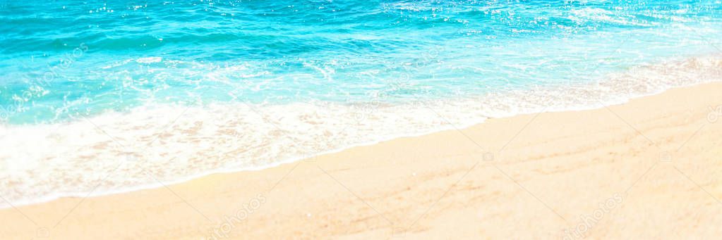 Soft wave of blue ocean on sandy beach Background with place for text. Tropical summer vacation concept