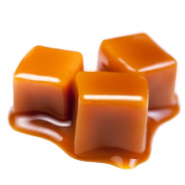 Caramel with sauce. Golden Butterscotch toffee candy caramels. Sweets  with copy space, macro. clipart