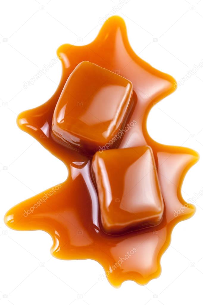 Toffee caramel candies close-up isolated on white background with copy space, macro