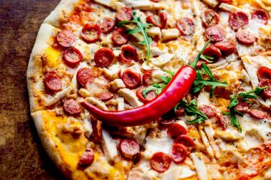  Biber biber ve koyu ahşap arka plan üzerinde lezzetli Topingler ile peynir biberli pizza. Üstten Görünüm 