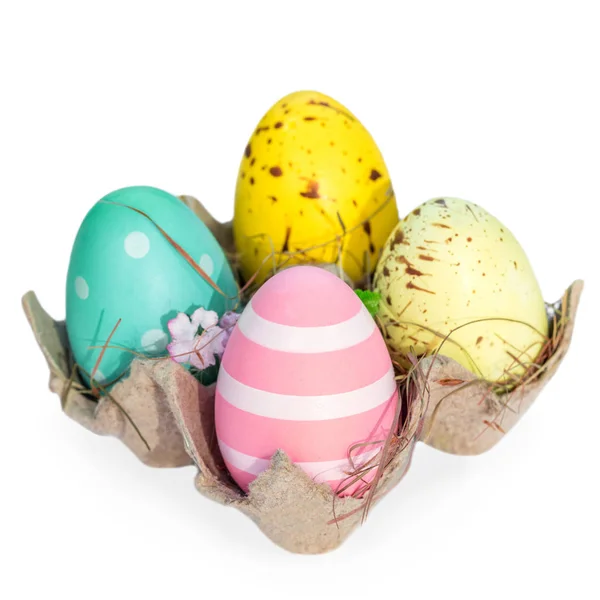 Easter eggs in egg cartoon box isolated  white  background close up. Festive decorations. Happy Easter