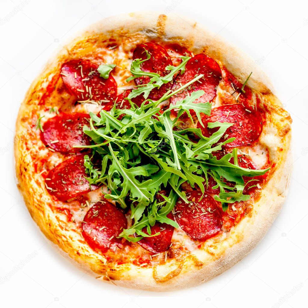 Original Italian pepperoni pizza with arugula isolated on white background