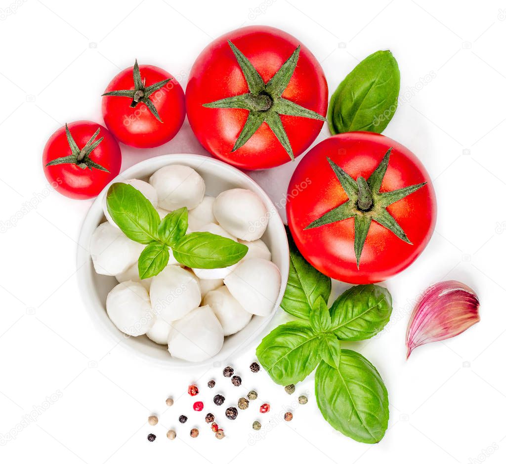 Top view of fresh tomatoes with basil leaves, mozzarella and spices on white background