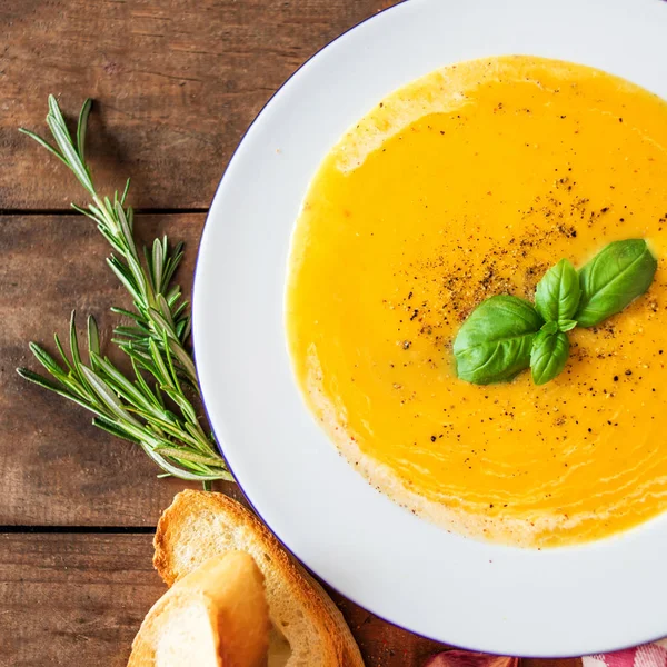 Close view of cream soup with pumpkin and carrot on wooden table — Stock Image Close View Cream Soup Pumpkin Carrot Wooden Table Royalty Free Stock Images