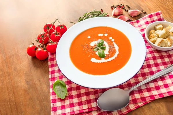 Vegetarian autumn pumpkin carrot cream soup with tomatoes on w — Stock Image Vegetarian autumn pumpkin carrot cream soup with tomatoes on w Royalty Free Stock Photos