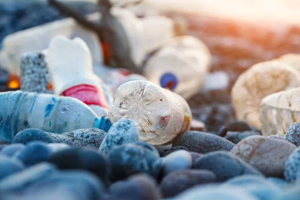 ocean water pollution with plastic waste and water bottles, spilled garbage on city sea beach, environmental ecological problem