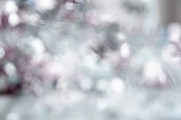 Hermoso Año Nuevo borroso desenfocado plata, rosa pálido, fondo gris. Bokeh mágico de Navidad —  Fotos de Stock