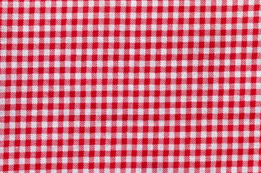 Kırmızı ve beyaz kareli kumaş dokusu. Parlak renkli pamuk arkaplanı