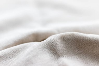 Doğal keten kumaş dokusu. Buruşuk buruşuk çuval bezi. Seçici odaklanma. Yakın görünüm