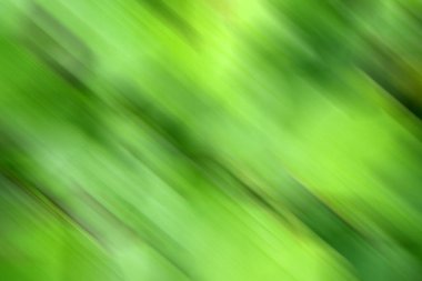 Yeşil renkli bulanık arkaplan. Karışık hareket dokusu. Soyut köşegen çizgiler duvar kağıdı