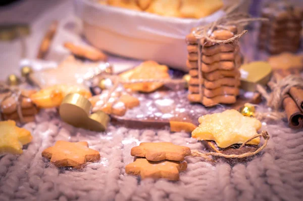 Gingerbread and sugar stars cookies on knitted background