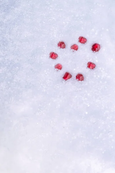 Winter heart of pomegranate grains on the snow background — Stock Photo, Image