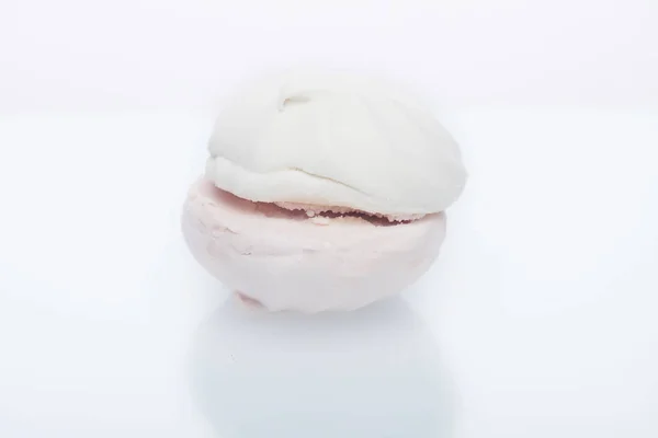 Wit-roze marshmallow met aardbeiensmaak op een witte plaat met reflectie — Stockfoto