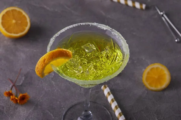 Thea liquor with lemon in a martini glass on a gray background — Stock Photo, Image