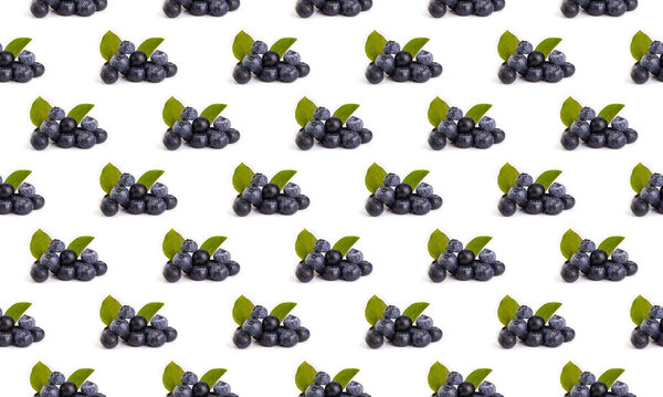 Colorful blueberry fruit pattern with green leaves on a white background, side view.