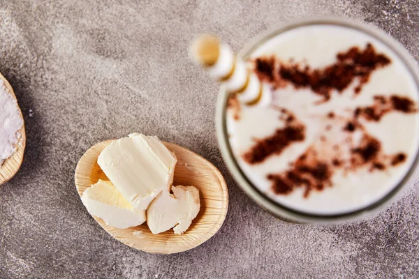 Fashionable food and drink glass of iced oolong tea with a layer of cream cheese foam with cocoa powder, a traditional Chinese drink on a gray background. Selective focus. Close-up.Copy space.