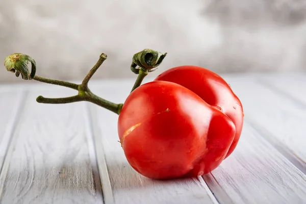 Ugly fruit or vegetable. Severely malformed mutant tomato. Food shops mostly prefer the best quality fruit and vegetables. Ugly fruit is not in high demand.