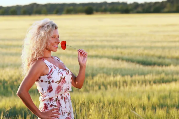 Happy mature woman with a long dress in summer evening — Stock Photo, Image