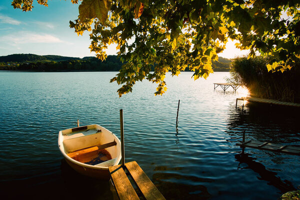 Peaceful atmosphere lake,boats and pier